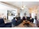 Bright, open living room featuring vaulted ceilings, modern ceiling fan, and a seamless flow into the kitchen at 381 Crossroads Dr, Social Circle, GA 30025