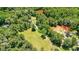 Aerial view of wooded property with lawn and mature trees at 3909 Laurens Ln, Snellville, GA 30039