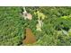 Stunning aerial view of wooded property with a large pond, showcasing natural beauty at 3909 Laurens Ln, Snellville, GA 30039