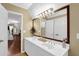 Bathroom featuring double sink vanity, large mirror and neutral decor at 3909 Laurens Ln, Snellville, GA 30039