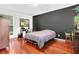 Well-lit bedroom with hardwood floors, desk and ample space at 3909 Laurens Ln, Snellville, GA 30039