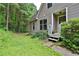 House exterior with covered porch, complemented by lush greenery and mature trees at 3909 Laurens Ln, Snellville, GA 30039