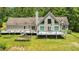 Back exterior of home features a large deck, lawn and garden at 3909 Laurens Ln, Snellville, GA 30039