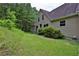 Home exterior with green lawn, mature trees, and neutral-toned siding at 3909 Laurens Ln, Snellville, GA 30039
