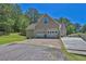 View of a two car garage with level driveway and a wheelchair access ramp at 3909 Laurens Ln, Snellville, GA 30039
