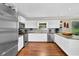 Bright kitchen featuring white cabinets, stainless steel appliances, and hardwood floors at 3909 Laurens Ln, Snellville, GA 30039