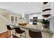 Bright kitchen features granite countertops, white cabinets, stainless steel appliances, and breakfast bar at 3909 Laurens Ln, Snellville, GA 30039