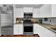 Updated kitchen featuring stainless steel appliances and granite countertops at 3909 Laurens Ln, Snellville, GA 30039
