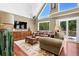 Open living room with vaulted ceiling, large windows, and hardwood floors at 3909 Laurens Ln, Snellville, GA 30039