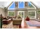 Open concept living room with vaulted ceiling, large windows, and hardwood floors at 3909 Laurens Ln, Snellville, GA 30039