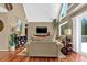 Spacious living room with vaulted ceiling, large windows, hardwood floors, and comfortable seating at 3909 Laurens Ln, Snellville, GA 30039