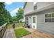 Back deck overlooking the backyard features a grill and a grassy rug at 4000 Mcpherson Drive, Acworth, GA 30101