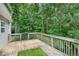 Wooden back deck overlooking the backyard with mature landscaping at 4000 Mcpherson Drive, Acworth, GA 30101