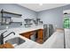 Finished basement bar with a sink, mini-fridge, custom shelving, and bright lighting at 4000 Mcpherson Drive, Acworth, GA 30101