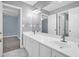 Modern bathroom featuring double sinks, white cabinets, and a large mirror at 4000 Mcpherson Drive, Acworth, GA 30101