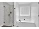 Modern bathroom featuring a standalone shower with glass door and bathtub at 4000 Mcpherson Drive, Acworth, GA 30101