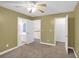 Cozy bedroom with neutral carpet, fan, and a view to the staircase at 4000 Mcpherson Drive, Acworth, GA 30101