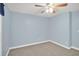 Bright carpeted bedroom featuring a ceiling fan and neutral paint palette at 4000 Mcpherson Drive, Acworth, GA 30101