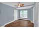 This bedroom features light-blue walls, wood floors, a window and a ceiling fan at 4000 Mcpherson Drive, Acworth, GA 30101