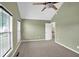 View of a carpeted bedroom featuring a ceiling fan, window, and neutral paint palette at 4000 Mcpherson Drive, Acworth, GA 30101