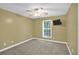 Bedroom with carpeted floors, ceiling fan, and a large window for natural light at 4000 Mcpherson Drive, Acworth, GA 30101