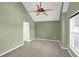 Spacious carpeted bedroom featuring a ceiling fan, window, and neutral paint palette at 4000 Mcpherson Drive, Acworth, GA 30101