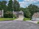 Inviting exterior view of a two-story home with a lush green lawn and attached garage, surrounded by mature trees at 4000 Mcpherson Drive, Acworth, GA 30101