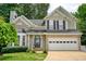 Beautiful two-story home with a brick-accented facade, an attached garage, and a well-maintained front lawn at 4000 Mcpherson Drive, Acworth, GA 30101