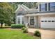 Front yard of a two-story home featuring well-maintained landscaping and an attached two-car garage at 4000 Mcpherson Drive, Acworth, GA 30101