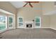 Spacious living room with large windows, a cozy fireplace, and neutral carpeting at 4000 Mcpherson Drive, Acworth, GA 30101