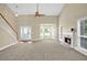 Open-concept living room with a fireplace, large windows, high ceilings, and a staircase at 4000 Mcpherson Drive, Acworth, GA 30101