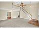 Bright, open living room featuring a fireplace, plush carpeting, and a staircase at 4000 Mcpherson Drive, Acworth, GA 30101