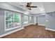 This living room features light-blue walls, two large windows and a fan at 4000 Mcpherson Drive, Acworth, GA 30101