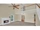 Bright living room featuring a fireplace, plush carpeting, high ceilings, and a ceiling fan at 4000 Mcpherson Drive, Acworth, GA 30101