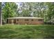 Spacious backyard featuring a well-maintained lawn and a brick exterior at 4400 Hickory Wood Ln, Atlanta, GA 30360