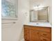 Bathroom vanity with wood cabinets, white countertop, and decorative mirror at 4400 Hickory Wood Ln, Atlanta, GA 30360