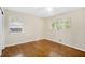 A bright bedroom featuring hardwood floors and two windows offering ample natural light at 4400 Hickory Wood Ln, Atlanta, GA 30360