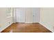 Well-lit bedroom with polished hardwood floors, with closet and doors at 4400 Hickory Wood Ln, Atlanta, GA 30360