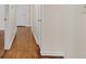 Long hallway with pristine hardwood flooring and neutral walls at 4400 Hickory Wood Ln, Atlanta, GA 30360