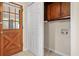 Practical laundry room with storage cabinets and convenient access to the outside at 4400 Hickory Wood Ln, Atlanta, GA 30360