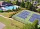 Aerial shot of tennis courts and pool, set amongst mature trees and lush landscaping in a neighborhood setting at 150 Ivy Chase Loop, Dallas, GA 30157