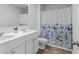 Bathroom featuring a double vanity, modern fixtures, and a blue floral shower curtain at 150 Ivy Chase Loop, Dallas, GA 30157