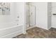 Bathroom with a soaking tub, a glass-enclosed shower, and practical shelving at 150 Ivy Chase Loop, Dallas, GA 30157