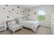 Bright bedroom featuring a full-size bed, toddler bed, and floral decorations at 150 Ivy Chase Loop, Dallas, GA 30157
