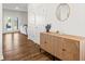 Inviting entryway features a stylish wood buffet, round mirror, and leads into a bright living space at 150 Ivy Chase Loop, Dallas, GA 30157