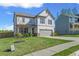 Traditional two-story home with a gray exterior, an attached two-car garage, and a beautifully landscaped front yard at 150 Ivy Chase Loop, Dallas, GA 30157