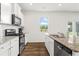 Modern kitchen featuring stainless steel appliances, granite counters, and ample cabinet space at 150 Ivy Chase Loop, Dallas, GA 30157