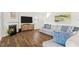 Living room featuring a fireplace, tv and hardwood floors at 150 Ivy Chase Loop, Dallas, GA 30157