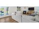 Bright living room with fireplace, plush sectional and hardwood floors at 150 Ivy Chase Loop, Dallas, GA 30157