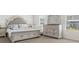 Serene main bedroom with a plush bed, ample natural light, and stylish furnishings at 150 Ivy Chase Loop, Dallas, GA 30157